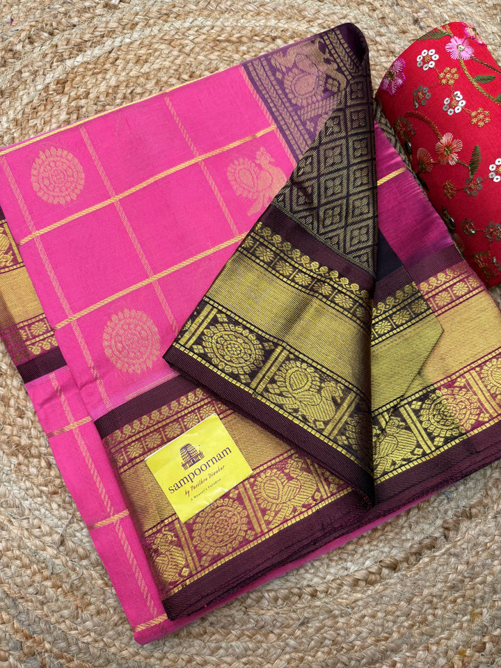 Baby Pink with Brown  , rich Zari checks with Mayil Chakram butta in the body , traditional borders and  rich Pallu Korvai Silk Cotton Saree
