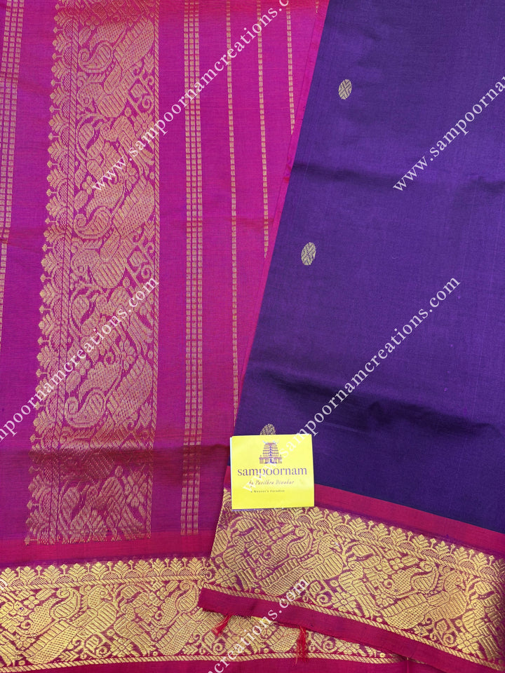 Wine with Magenta , Rich Zari Butta in the body , traditional borders and rich Pallu Silk Cotton Saree