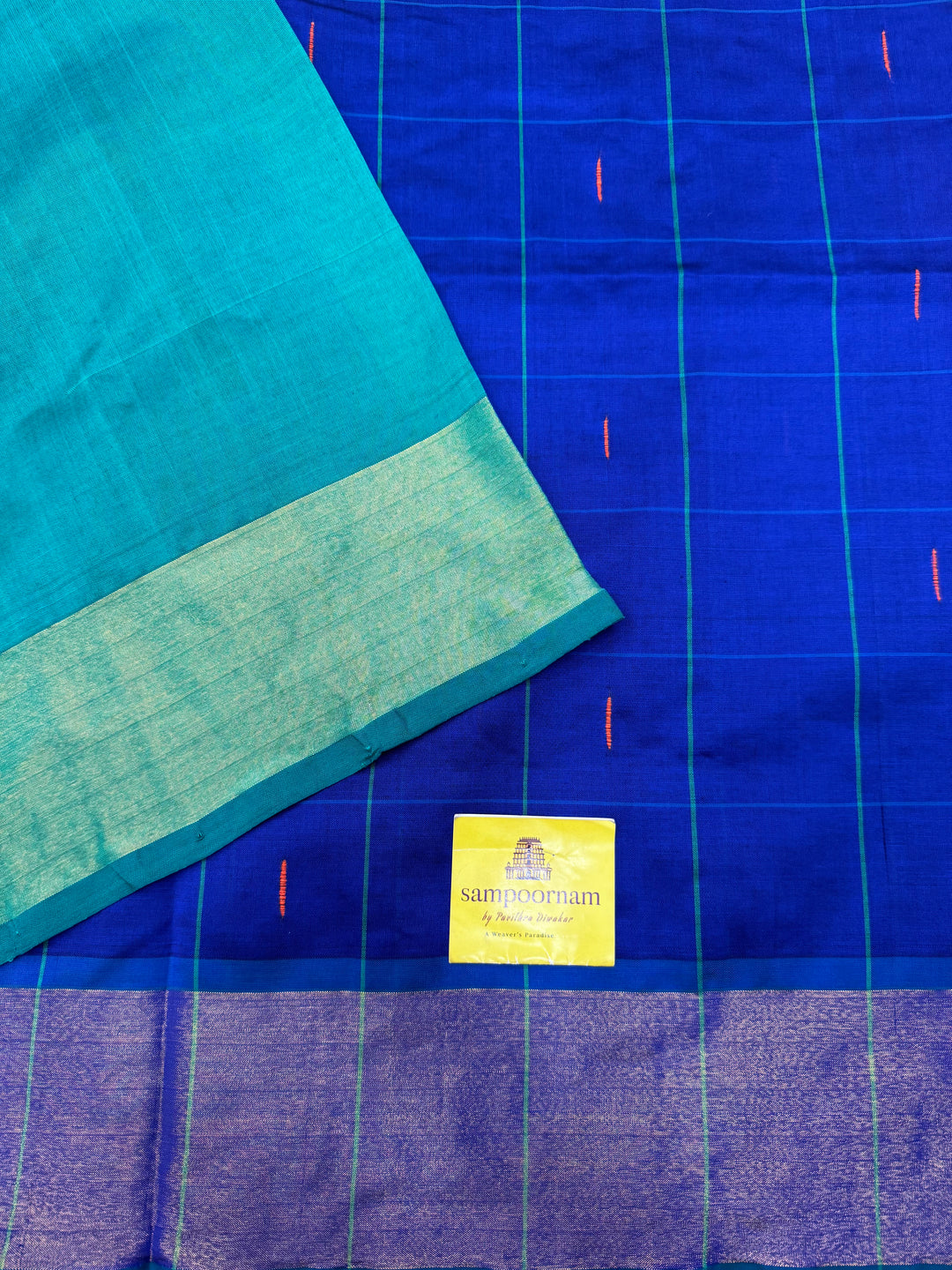 Blue with Green , checks in the body and rain drop thread butta in the body and Pallu Semi Silk Cotton Saree