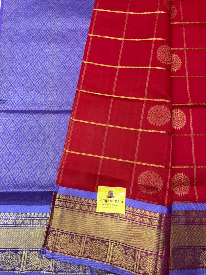 Red with Lilac  , rich Zari checks with Mayil Chakram butta in the body , traditional borders and  rich Pallu Korvai Silk Cotton Saree