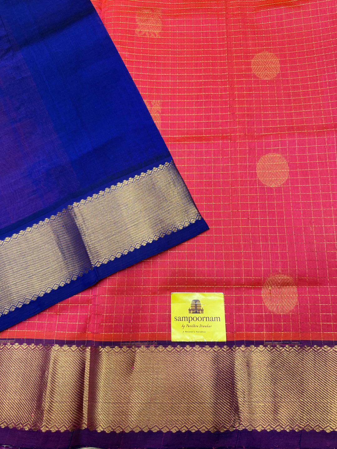 Peachish Pink with Blue  , rich Zari checks with Mayil Chakram butta in the body , traditional borders and rich Pallu Korvai Silk Cotton Saree