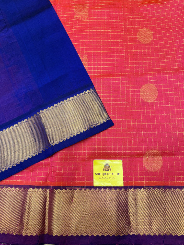 Peachish Pink with Blue  , rich Zari checks with Mayil Chakram butta in the body , traditional borders and rich Pallu Korvai Silk Cotton Saree