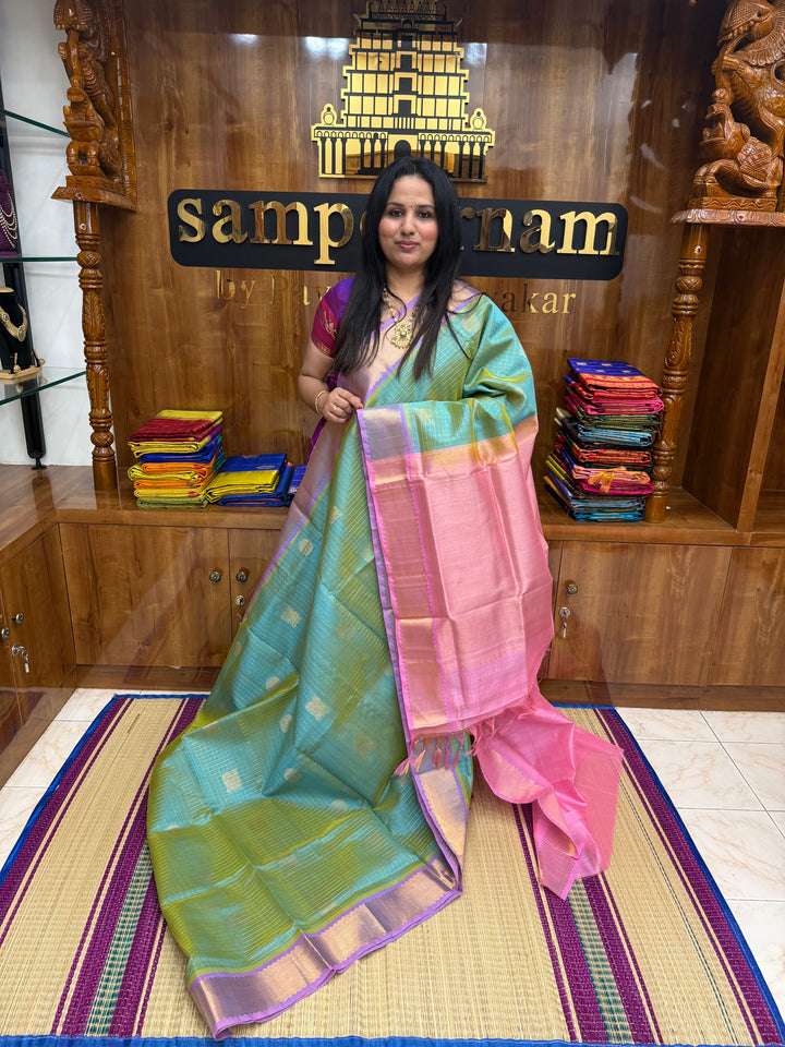 Double Shaded Sea Green with Baby Pink  , rich Zari checks with Mayil Chakram butta in the body , traditional borders and rich Pallu Korvai Silk Cotton Saree