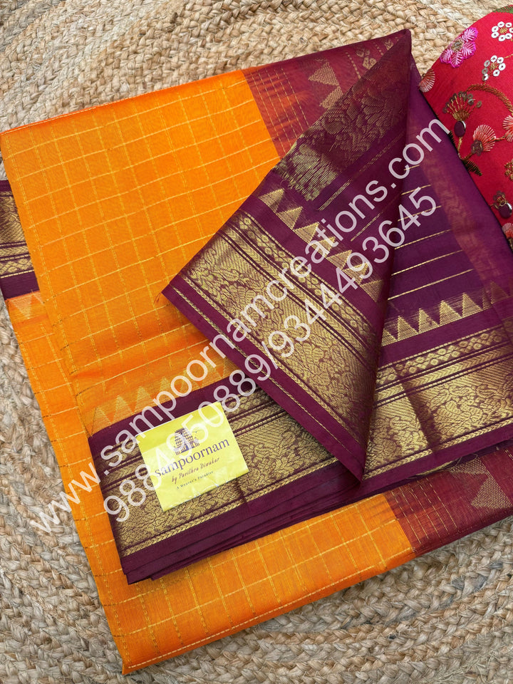 Kanakambaram with Maroon  , rich Zari checks in the body , traditional borders with temple design  and rich Pallu Korvai Silk Cotton