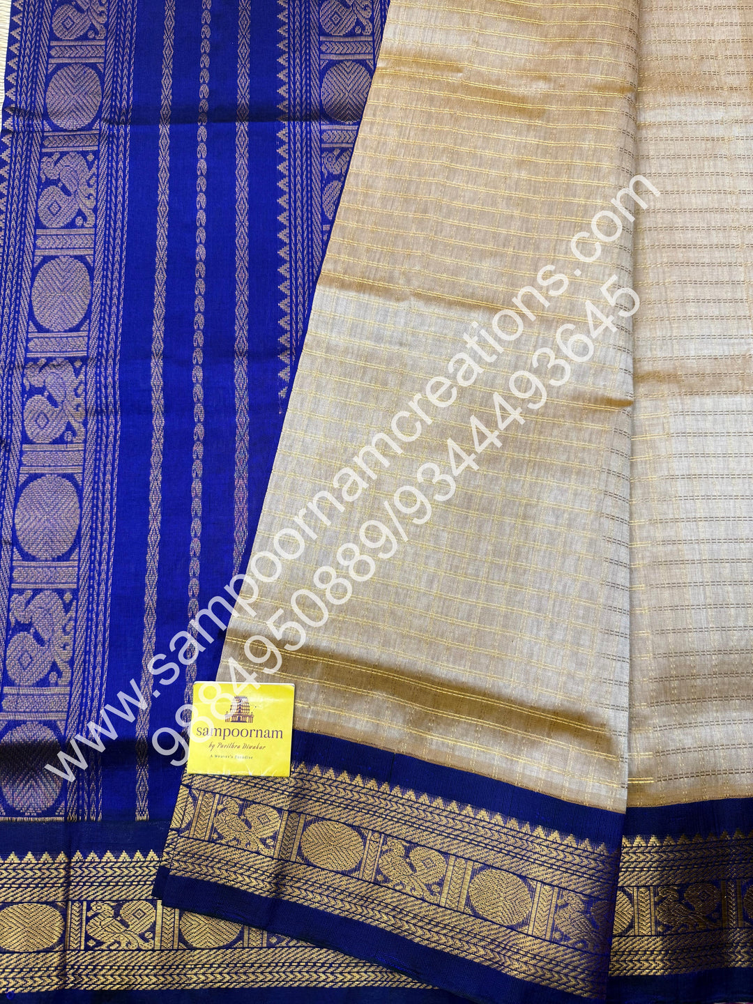 Beige with Dark Blue  , rich Zari checks in the body , traditional borders and rich Pallu Korvai Silk Cotton