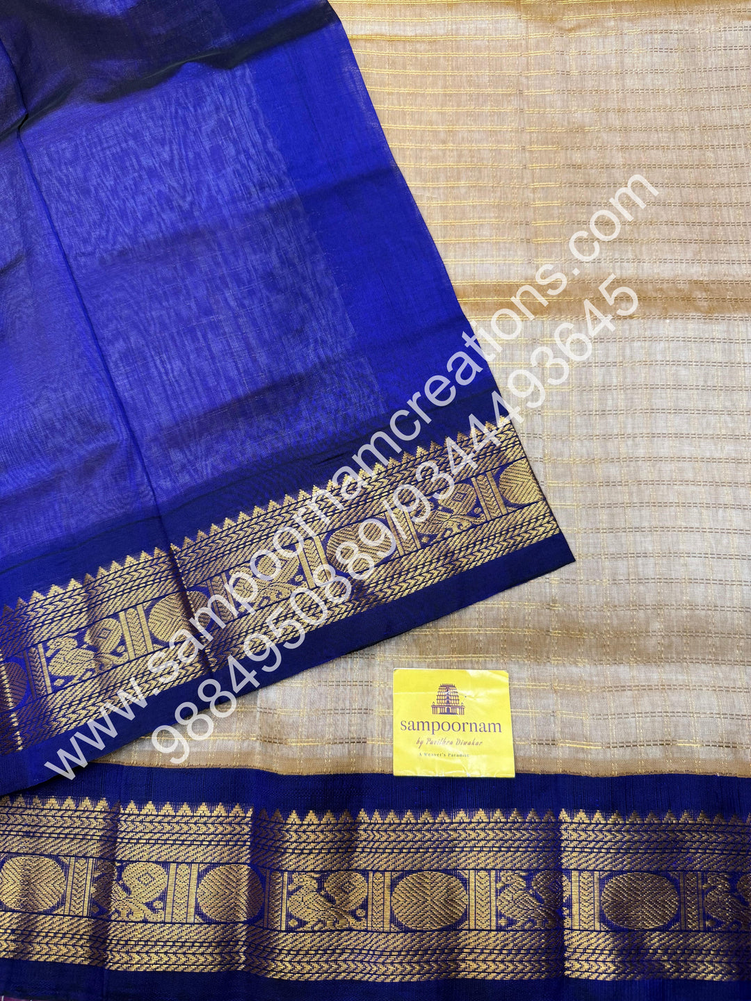 Beige with Dark Blue  , rich Zari checks in the body , traditional borders and rich Pallu Korvai Silk Cotton