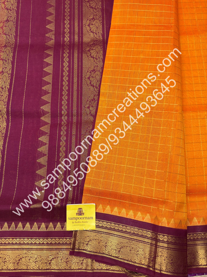 Kanakambaram with Maroon  , rich Zari checks in the body , traditional borders with temple design  and rich Pallu Korvai Silk Cotton