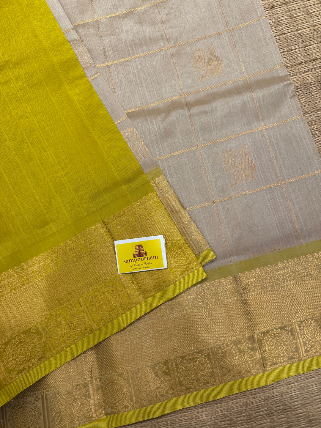 Offwhite with Lemon Yellow , rich Zari checks in the body , Mayil and Chakram butta ,traditional borders and grand Pallu Silk Cotton Saree