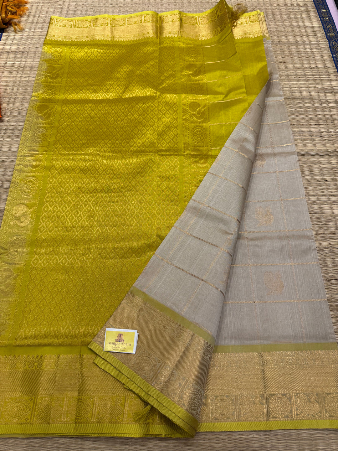 Offwhite with Lemon Yellow , rich Zari checks in the body , Mayil and Chakram butta ,traditional borders and grand Pallu Silk Cotton Saree