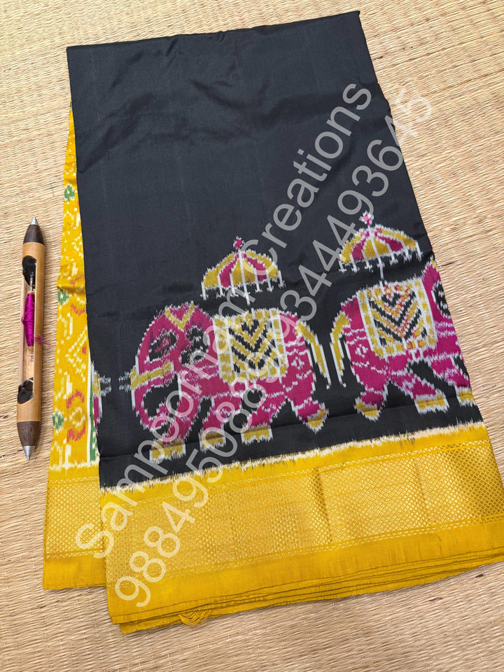 A traditional Black and Mustard combo with Majestic Elephants prints on one side border with traditional border and rich Pallu Pure Pochampally Silk Saree