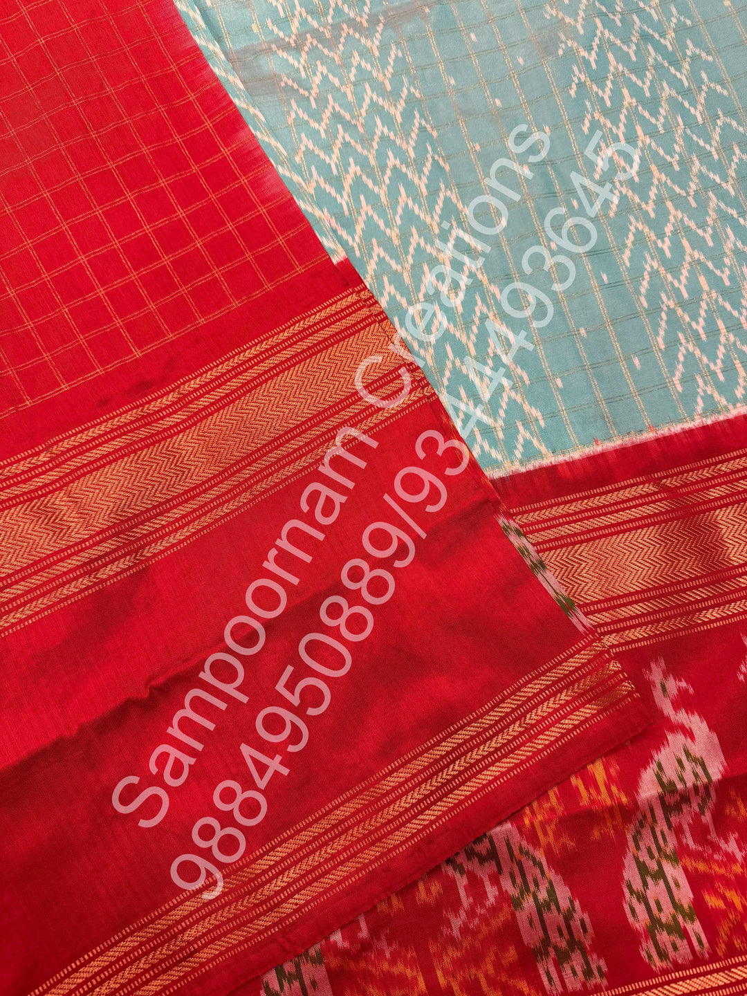 A Gorgeous Pastel Blue with Red saree , with rich Zari checks in the body and one side big Peacock design border and Grand Pallu Pure Pochampally Silk Saree