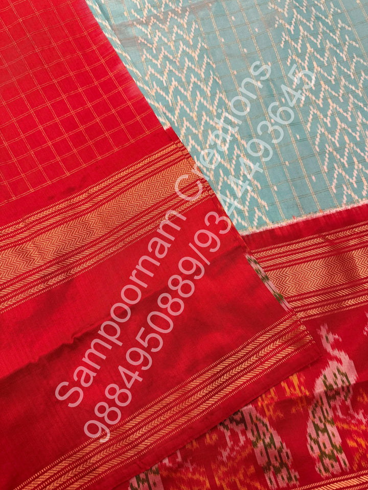 A Gorgeous Pastel Blue with Red saree , with rich Zari checks in the body and one side big Peacock design border and Grand Pallu Pure Pochampally Silk Saree