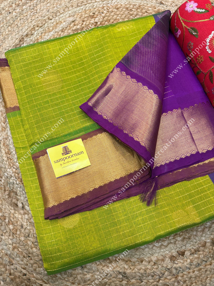 Light Green with Magenta  , rich Zari checks in the body , Mayil and Chakram rich butta in the body , traditional border rich Pallu Silk Cotton Saree