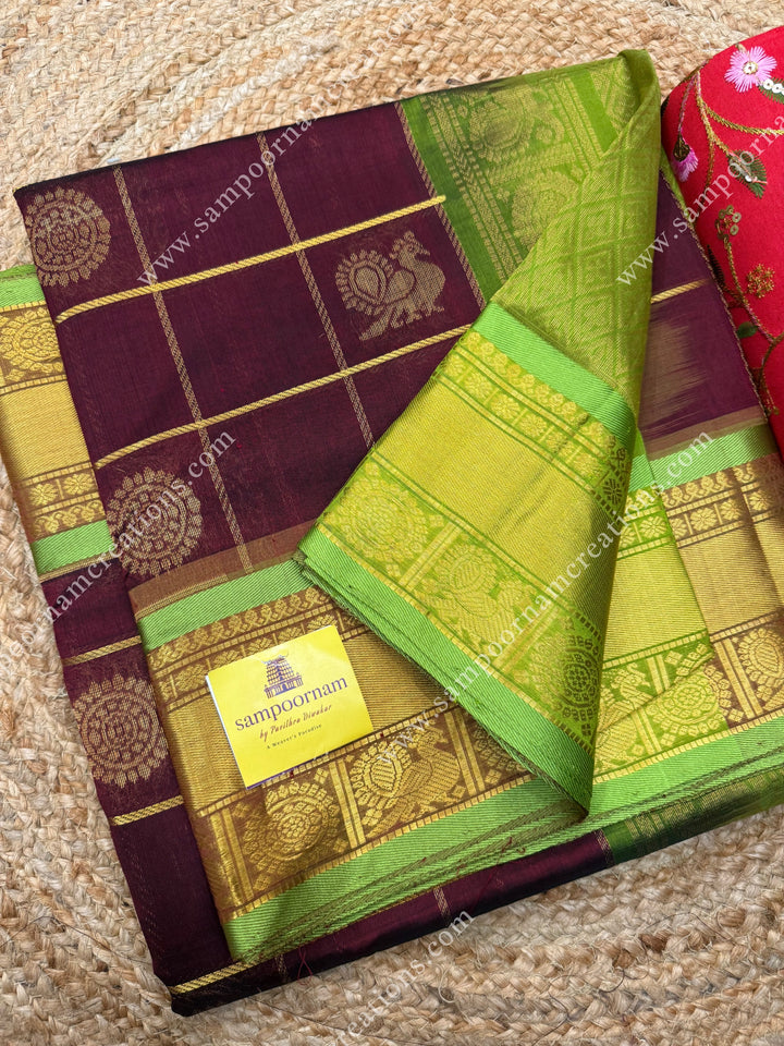 Arakku with Leaf Green  , rich Zari checks in the body , Mayil and Chakram rich butta in the body , traditional border rich Pallu Silk Cotton Saree