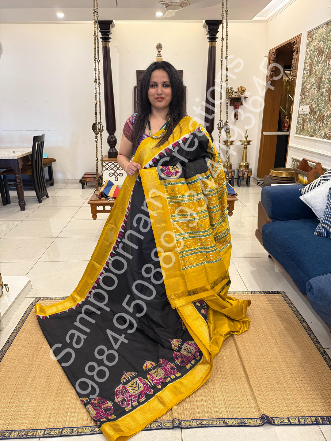 A traditional Black and Mustard combo with Majestic Elephants prints on one side border with traditional border and rich Pallu Pure Pochampally Silk Saree