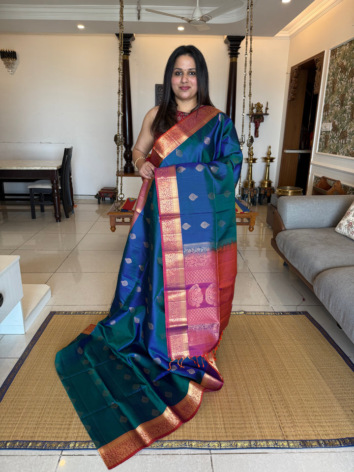 Traditional Mayilkazhuthu Blue with Orangish Pink , Rich Zari Motifs in the Body and Traditional Rich Pallu Pure Soft Silk Saree