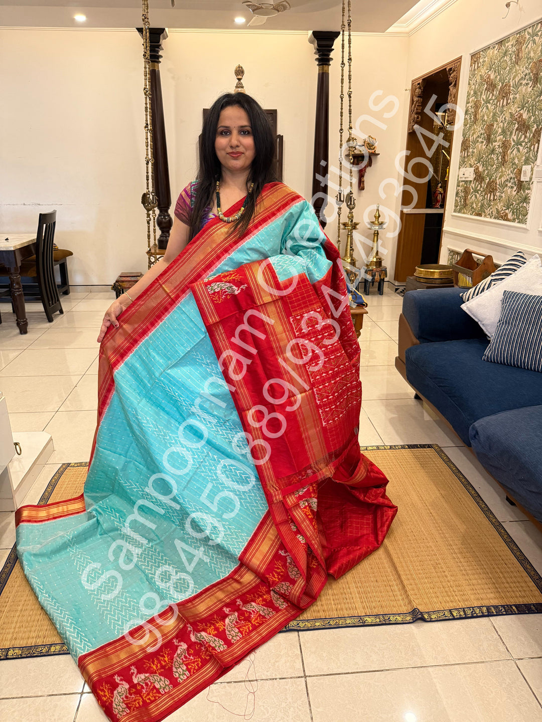 A Gorgeous Pastel Blue with Red saree , with rich Zari checks in the body and one side big Peacock design border and Grand Pallu Pure Pochampally Silk Saree