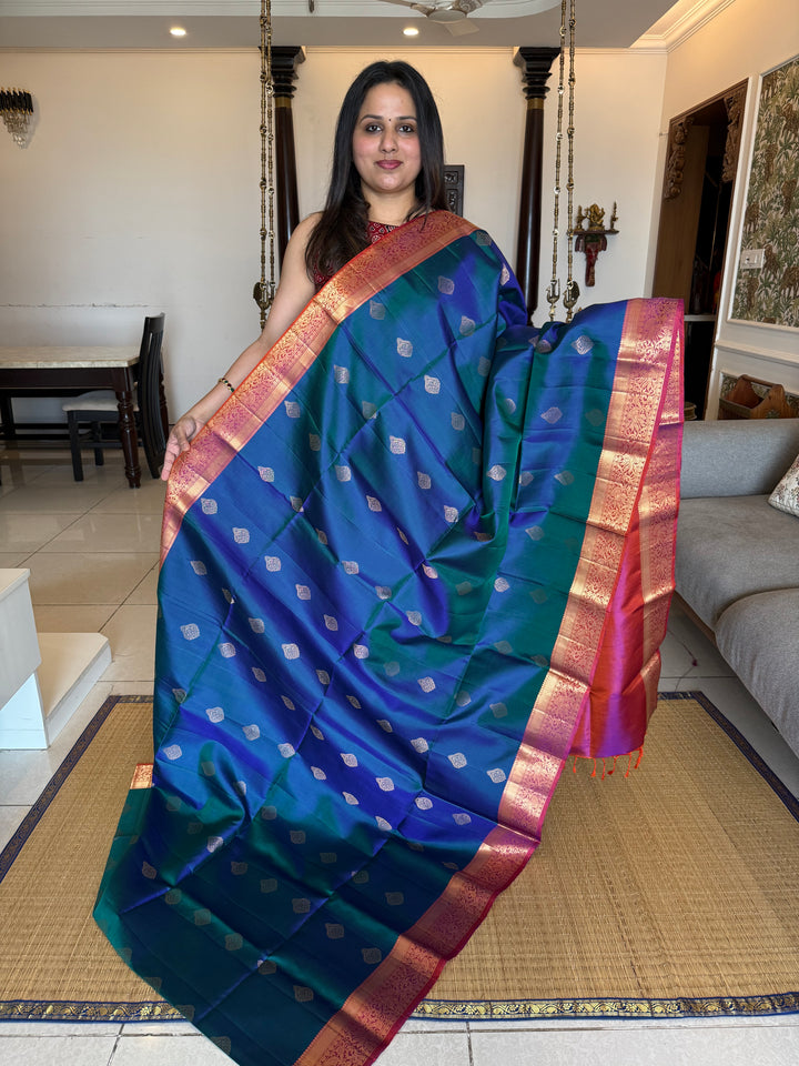 Traditional Mayilkazhuthu Blue with Orangish Pink , Rich Zari Motifs in the Body and Traditional Rich Pallu Pure Soft Silk Saree