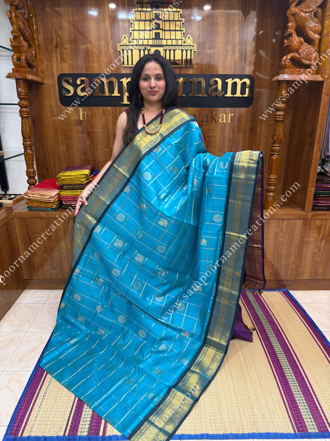 Ramar Blue with Purple  , rich Zari checks in the body , Mayil and Chakram rich butta in the body , traditional border rich Pallu Silk Cotton Saree