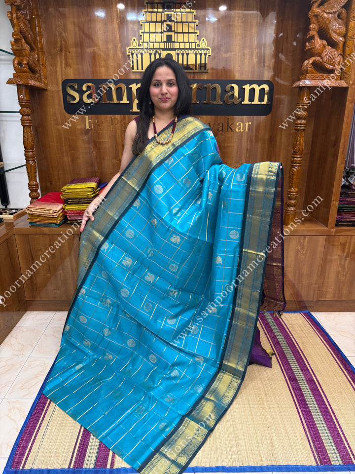 Ramar Blue with Purple  , rich Zari checks in the body , Mayil and Chakram rich butta in the body , traditional border rich Pallu Silk Cotton Saree