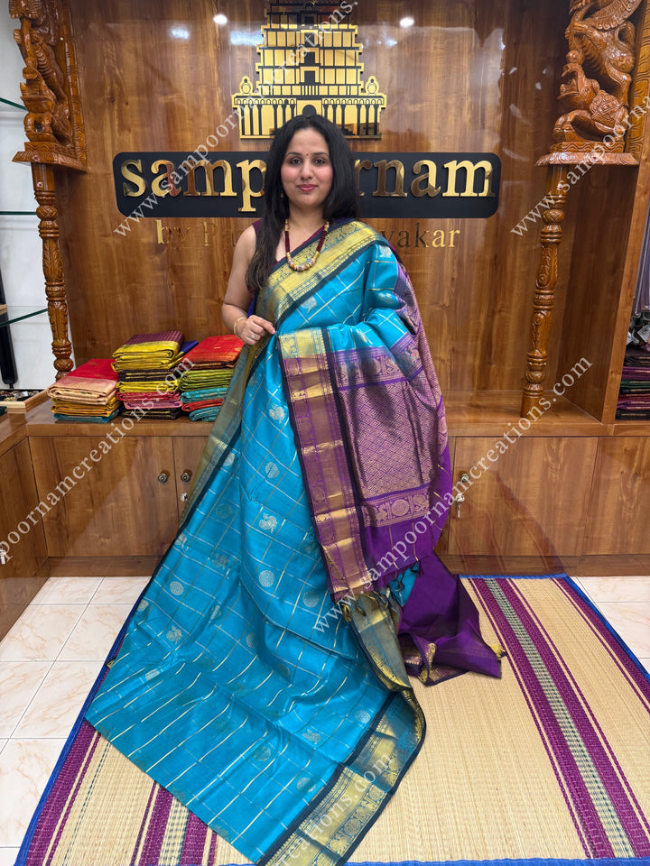 Ramar Blue with Purple  , rich Zari checks in the body , Mayil and Chakram rich butta in the body , traditional border rich Pallu Silk Cotton Saree