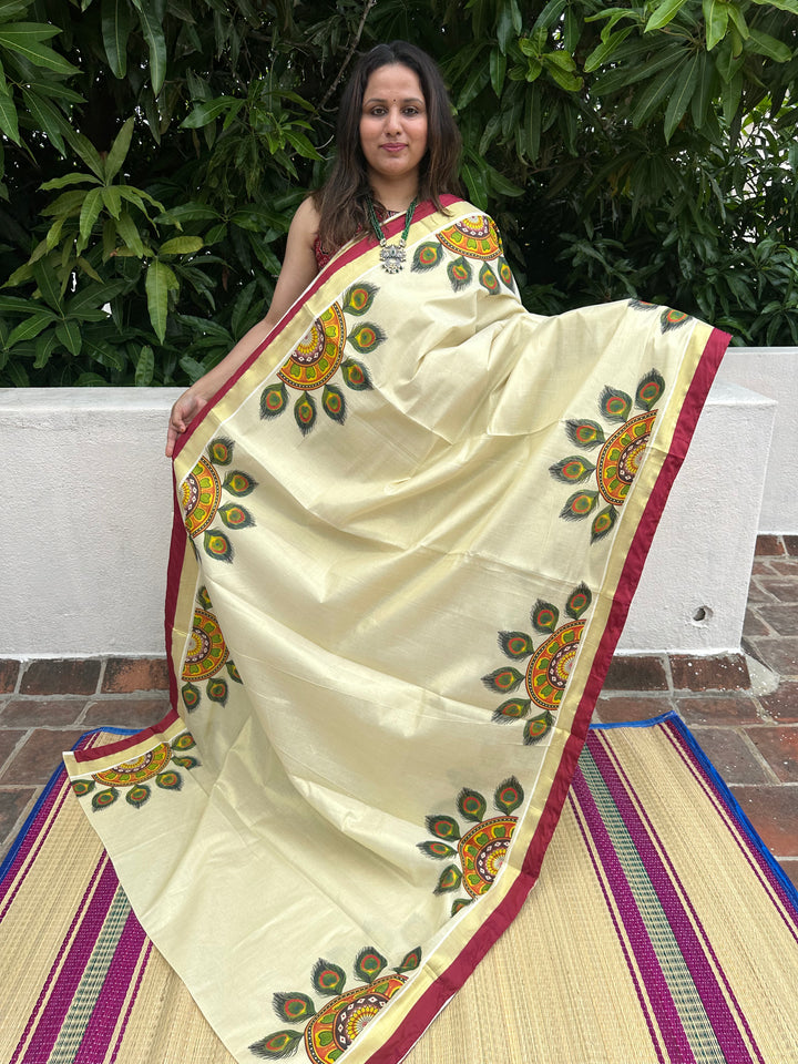 Kerala Tissue Saree with Peackock Feather Rangoli Motif and Maroon Piping in Borders