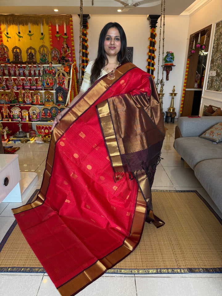 Red with Brown , rich Zari checks in the body , Mayil and Chakram butta , traditional borders and zari Pallu Silk Cotton Saree