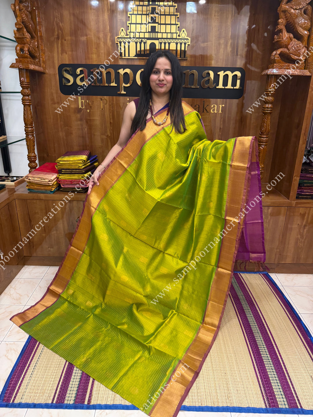 Light Green with Magenta  , rich Zari checks in the body , Mayil and Chakram rich butta in the body , traditional border rich Pallu Silk Cotton Saree