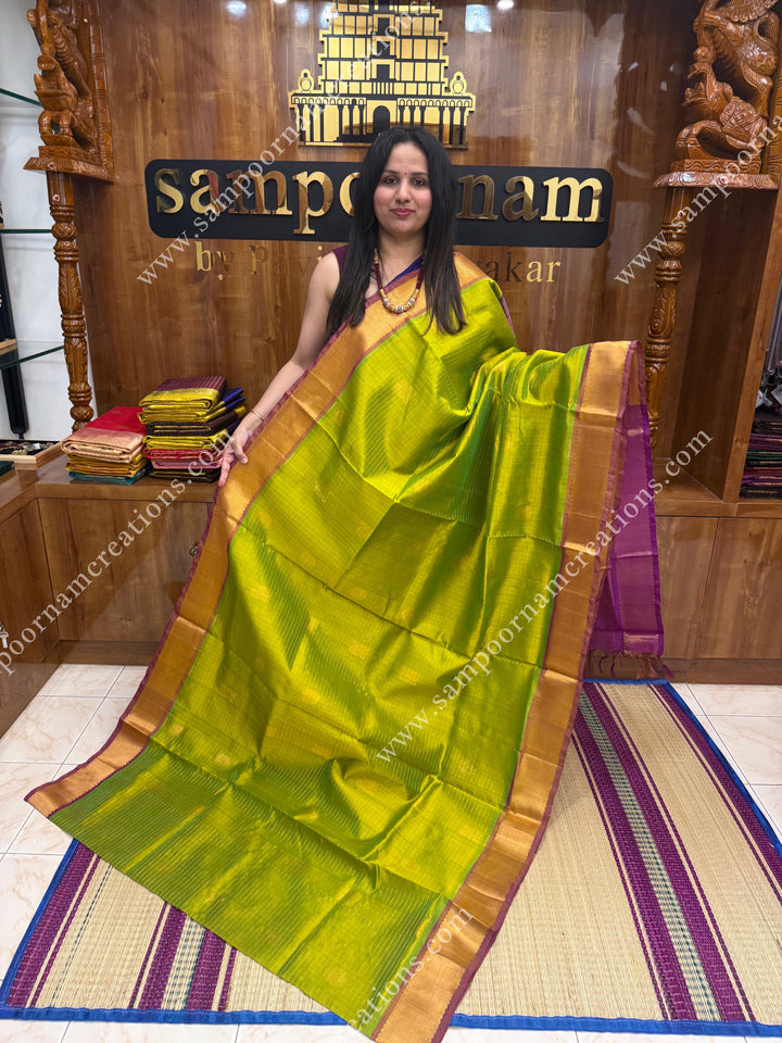 Light Green with Magenta  , rich Zari checks in the body , Mayil and Chakram rich butta in the body , traditional border rich Pallu Silk Cotton Saree
