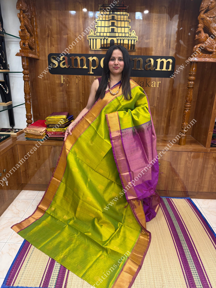 Light Green with Magenta  , rich Zari checks in the body , Mayil and Chakram rich butta in the body , traditional border rich Pallu Silk Cotton Saree