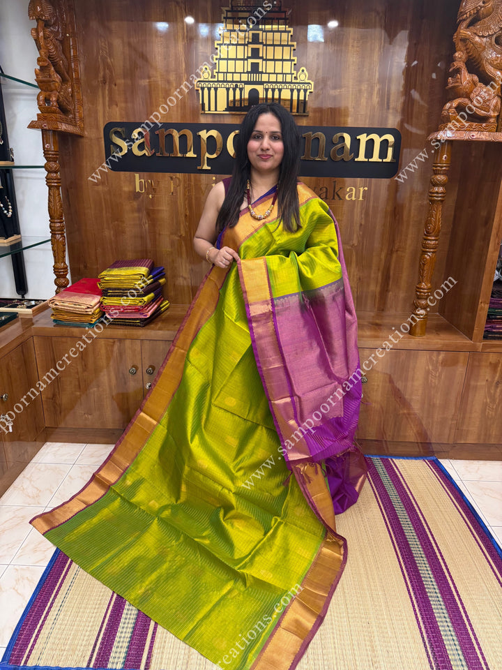 Light Green with Magenta  , rich Zari checks in the body , Mayil and Chakram rich butta in the body , traditional border rich Pallu Silk Cotton Saree