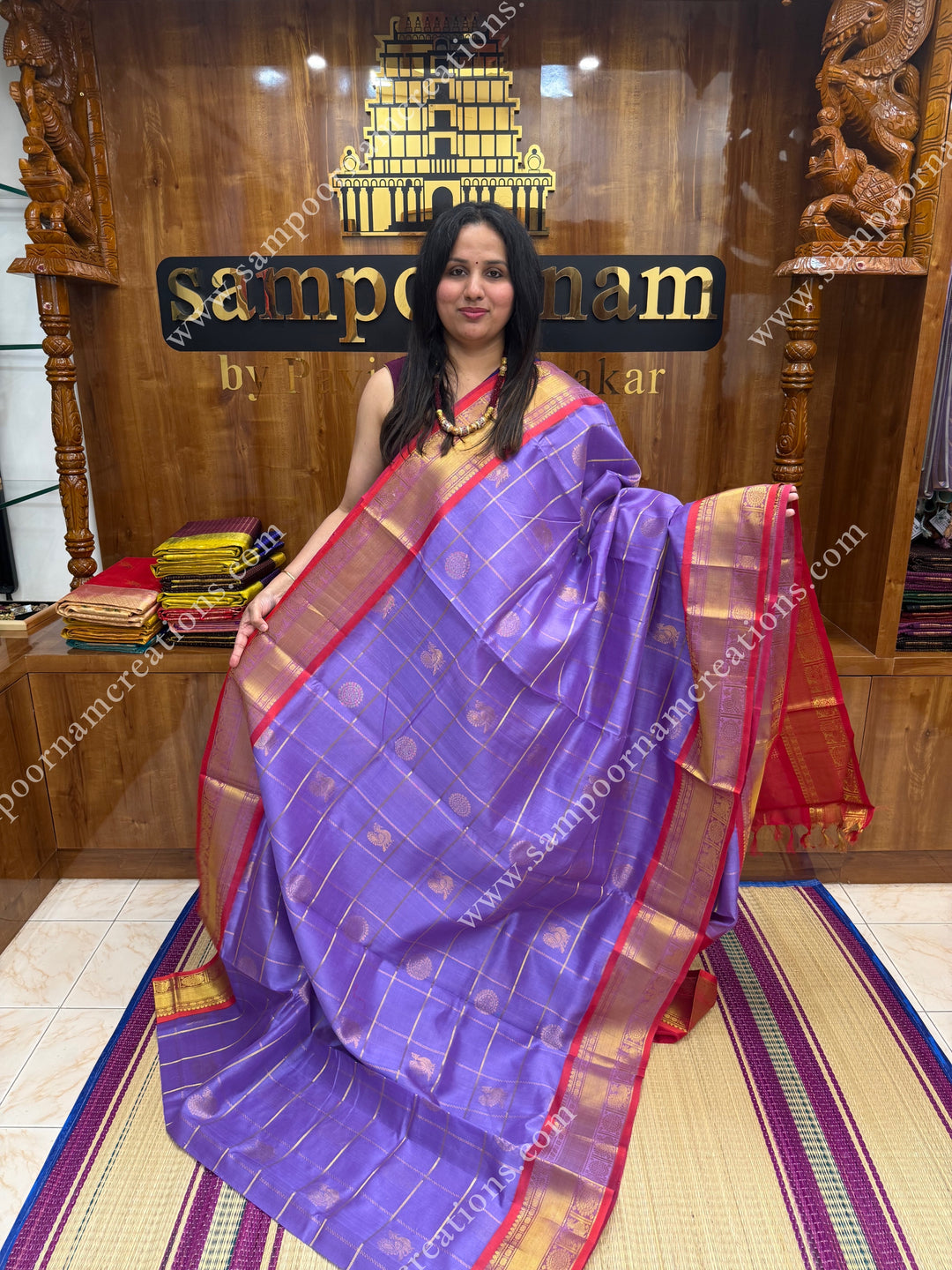 Lilac with Red  , rich Zari checks in the body , Mayil and Chakram rich butta in the body , traditional border rich Pallu Silk Cotton Saree