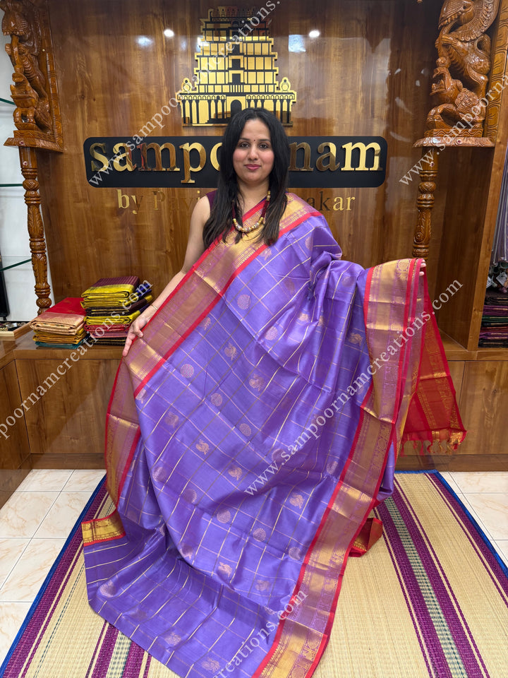 Lilac with Red  , rich Zari checks in the body , Mayil and Chakram rich butta in the body , traditional border rich Pallu Silk Cotton Saree