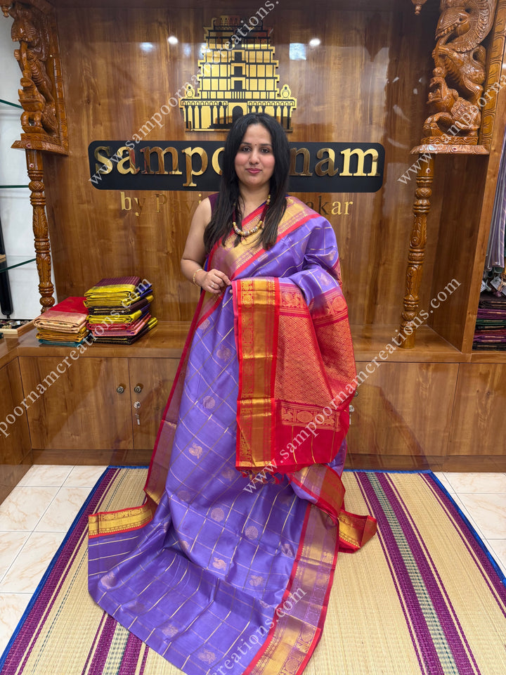Lilac with Red  , rich Zari checks in the body , Mayil and Chakram rich butta in the body , traditional border rich Pallu Silk Cotton Saree