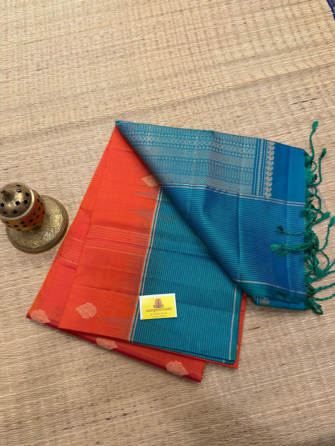 Orangish Red with Turquoise Blue, Vertical Silver and Fold Zari Lines with Rich Butta in the body and Grand Pallu Pure Soft Silk Saree