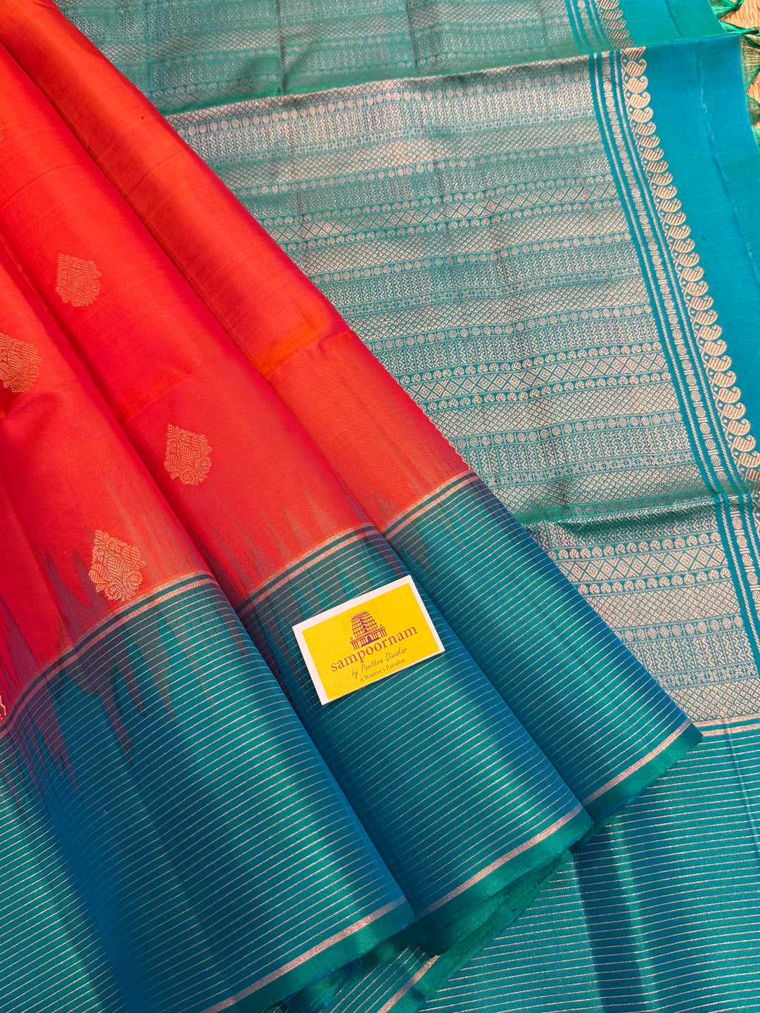 Orangish Red with Turquoise Blue, Vertical Silver and Fold Zari Lines with Rich Butta in the body and Grand Pallu Pure Soft Silk Saree