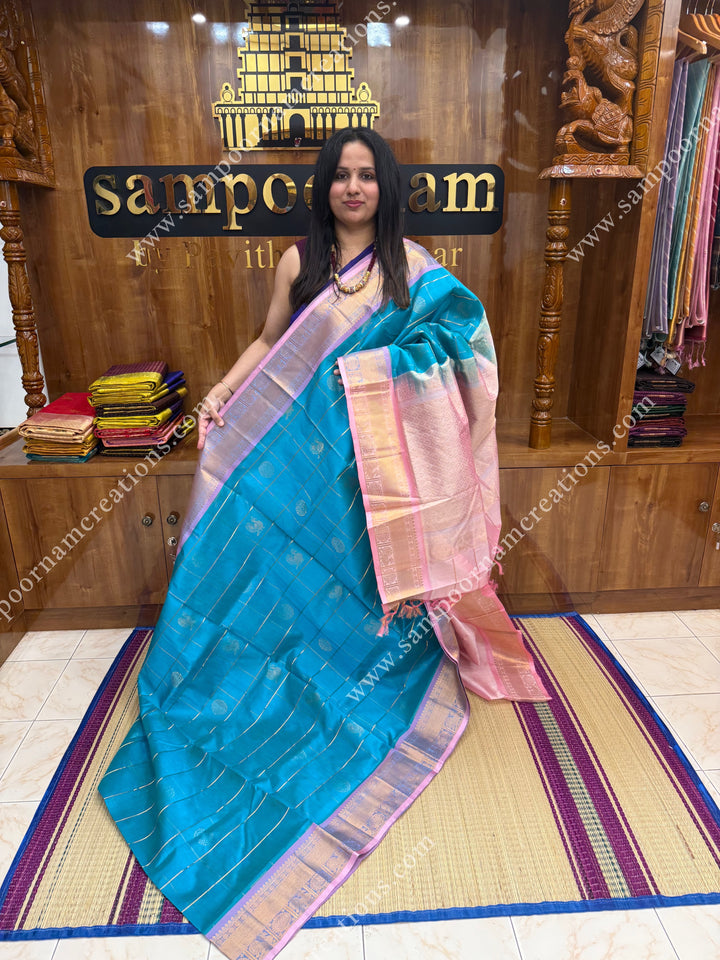 Turquoise Blue with Baby Pink  , rich Zari checks in the body , Mayil and Chakram rich butta in the body ,traditional border rich Pallu Silk Cotton Saree