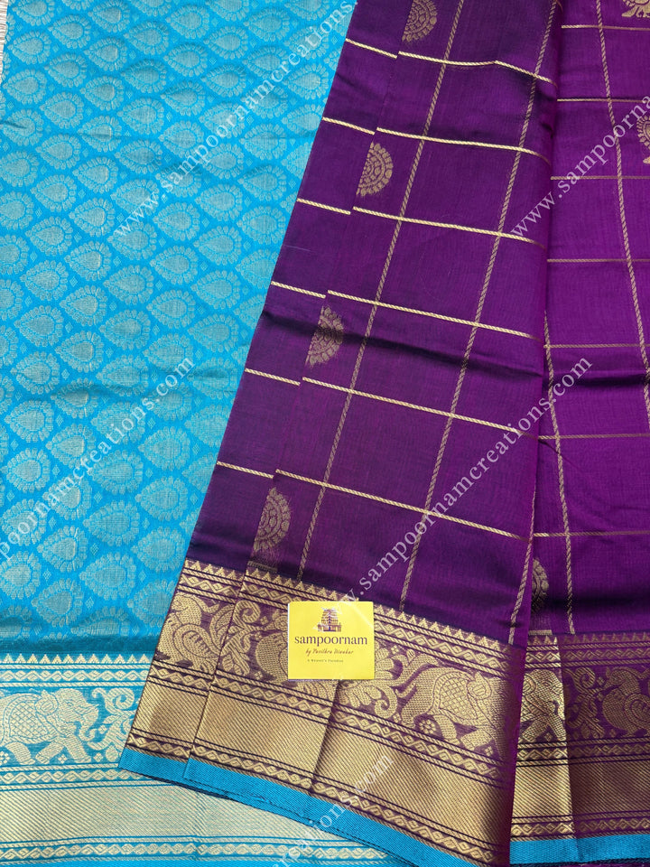 Wine with Turquoise Blue  , rich Zari checks in the body , Mayil and Chakram rich butta in the body , one side Long traditional border rich Pallu Silk Cotton Saree