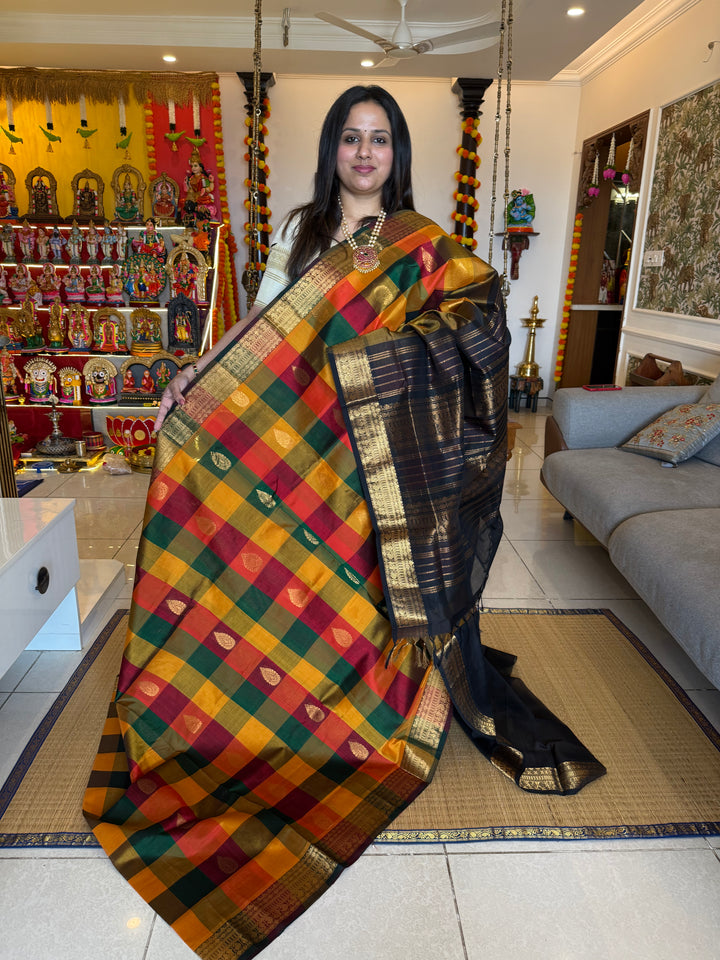 Red , Green and Manjal with Black , mango butta in the body , traditional borders and rich Pallu Silk Cotton Saree