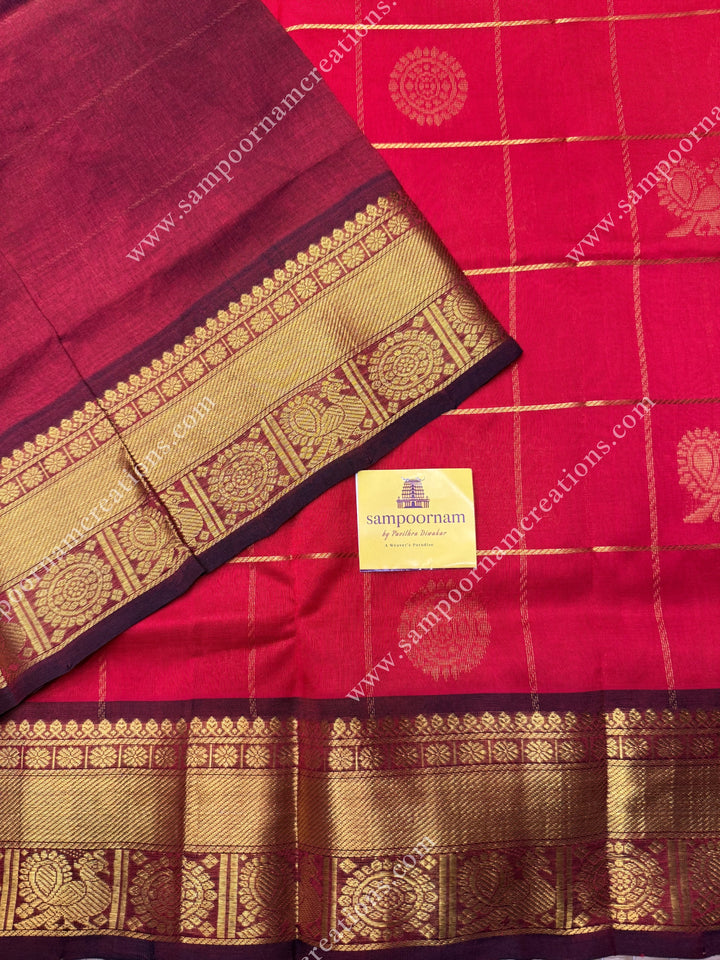 Bright Red with Arakku  , rich Zari checks in the body , Mayil and Chakram rich butta in the body , traditional border rich Pallu Silk Cotton Saree