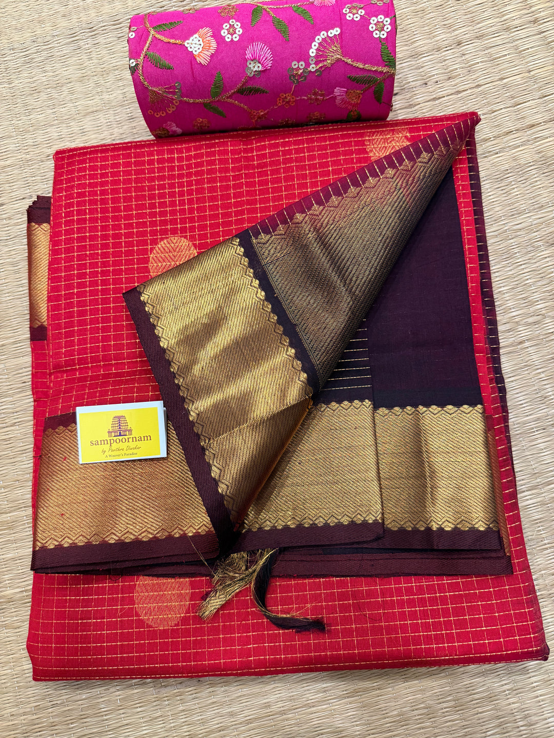Red with Brown , rich Zari checks in the body , Mayil and Chakram butta , traditional borders and zari Pallu Silk Cotton Saree