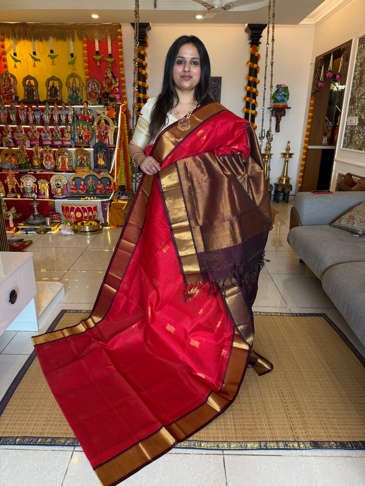 Red with Brown , rich Zari checks in the body , Mayil and Chakram butta , traditional borders and zari Pallu Silk Cotton Saree