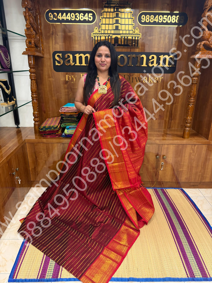 Dark Maroon with Red , Veldhari Zari Lines in the Body , Traditional Kanchi border , Rich Pallu , Pure Silk Cotton Saree
