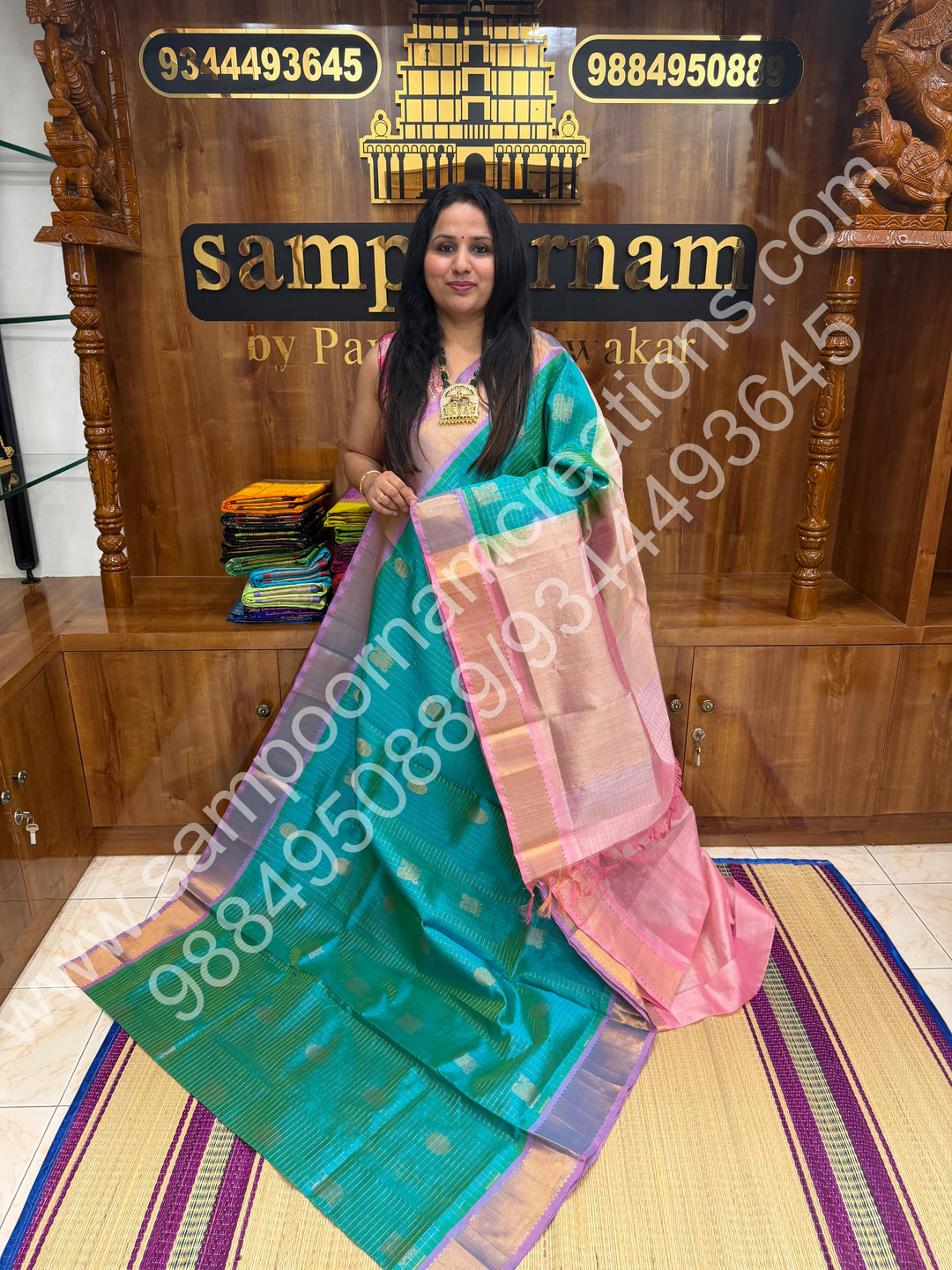 Double Shaded Sea Green with Baby Pink  , Rich Mayil and Chakram butta in the body with Zari Checks , Traditional borders and Rich Pallu Pure Silk Cotton Saree