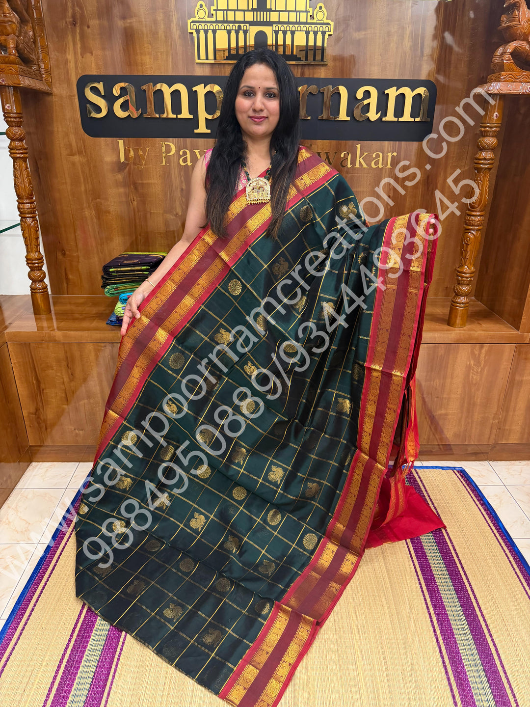 Bottle Green with Red  , Rich Mayil and Chakram butta in the body with Zari Checks , Traditional borders and Rich Pallu Pure Silk Cotton Saree