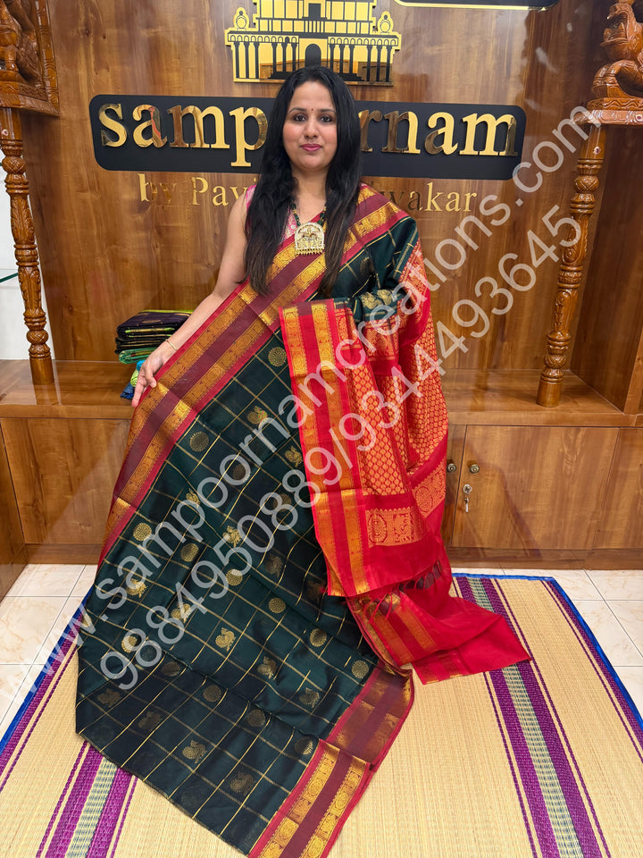 Bottle Green with Red  , Rich Mayil and Chakram butta in the body with Zari Checks , Traditional borders and Rich Pallu Pure Silk Cotton Saree