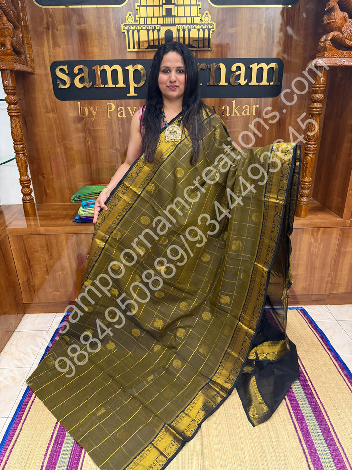 Sage Green with Black , Rich Mayil and Chakram butta in the body with Zari Checks , Traditional borders and Rich Pallu Pure Silk Cotton Saree