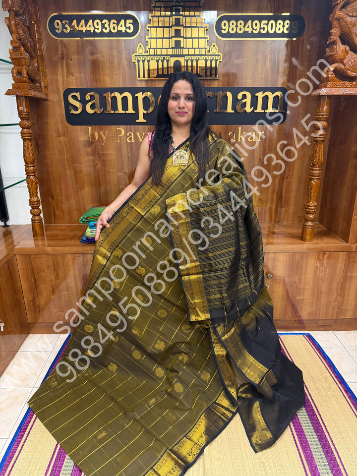 Sage Green with Black , Rich Mayil and Chakram butta in the body with Zari Checks , Traditional borders and Rich Pallu Pure Silk Cotton Saree