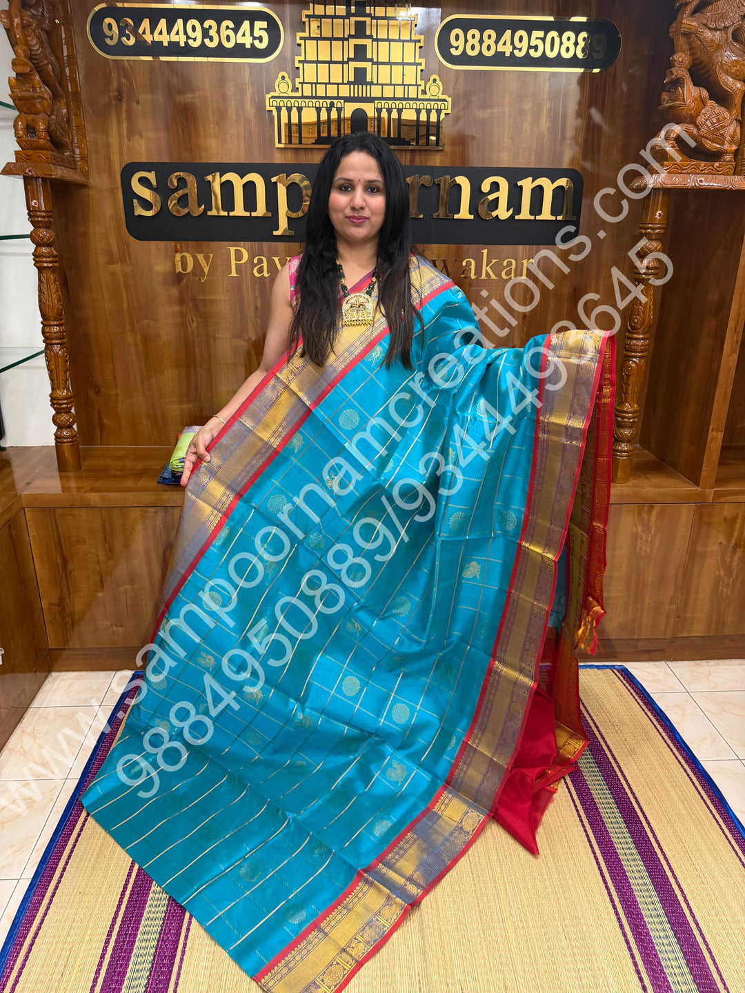 Ramar Blue with Red  , Rich Mayil and Chakram butta in the body with Zari Checks , Traditional borders and Rich Pallu Pure Silk Cotton Saree