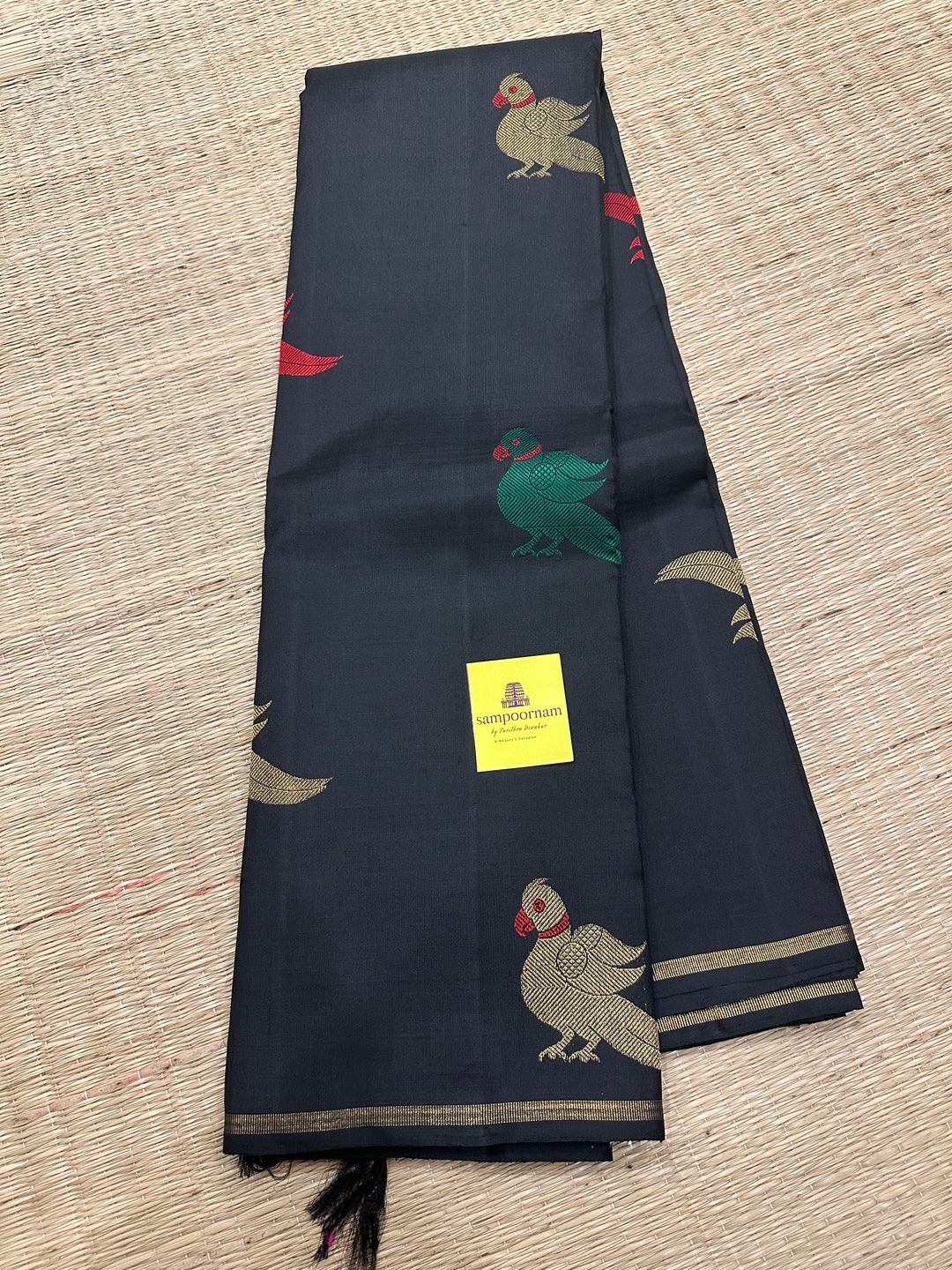 A Classic Black Saree with Kalakshetra Kili Butta in the body and Palla , with green and red thread work and gold Zari work, Rich Pallu Pure Kanjivaram Silk Saree